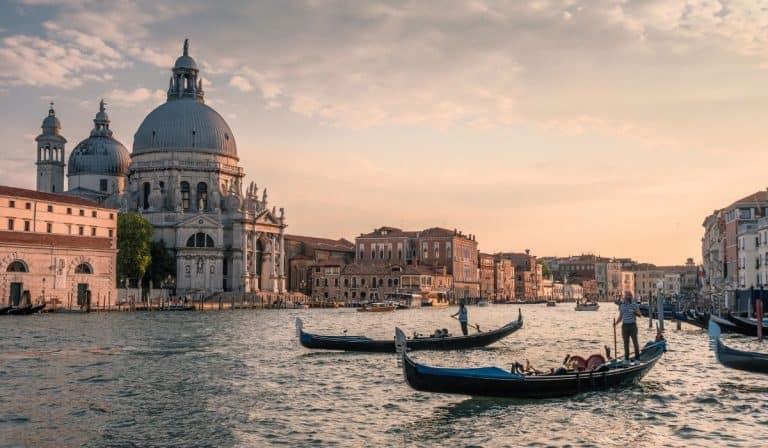 Exploring the Venetian Lagoon Islands 38 Gondolas on the waters of Venetian lagoon during a pale pink sunset.
