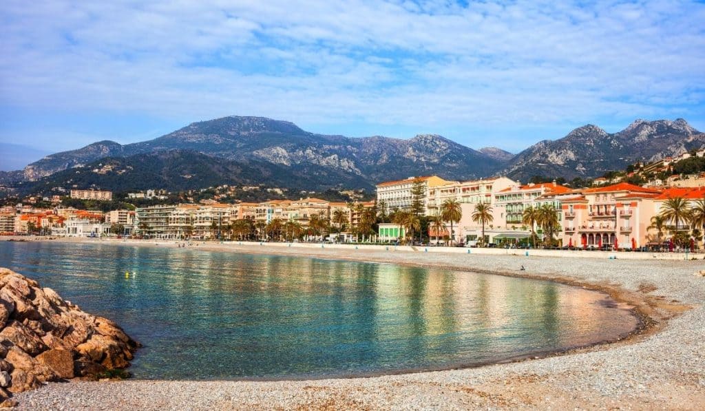15 Best Things to do in Menton, France 5 Plage du Fossan with houses reflecting on the water in Menton.